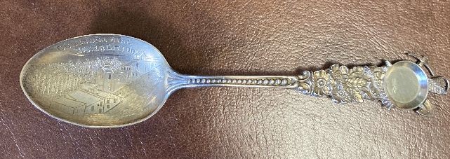 Souvenir Mining Spoon Golconda Mine.jpg - SOUVENIR MINING SPOON GOLCONDA MINE, BAKER CO., OR Sterling silver spoon, 5 3/8 in. long, engraved mining scene in bowl, bowl marked GOLCONDA MINE, BAKER CITY OR, handle front has floral decoration with dots down to the bowl and a miners gold pan with pick and shovel wrapped in sterling rope at top, reverse is marked Sterling and maker’s mark of Codding Bros. & Heilborn Co. (North Attleboro, MA. 1879-1918), excellent condition  [The Golconda Mine is a historic gold mine located in Baker County, Oregon, approximately 5 miles north of the town of Sumpter. The mine is located along Fruit Creek, in the Powder River watershed. The Golconda Mine’s major period of activity was 1897-1904. There are approximately 7,000 feet of underground workings including a 510 foot shaft. Today, two adits at the level of Fruit Creek have been observed and both are collapsed and discharging water. The Golconda Mine is currently owned by Armada Mining, Inc. of Vancouver, British Columbia, Canada.]